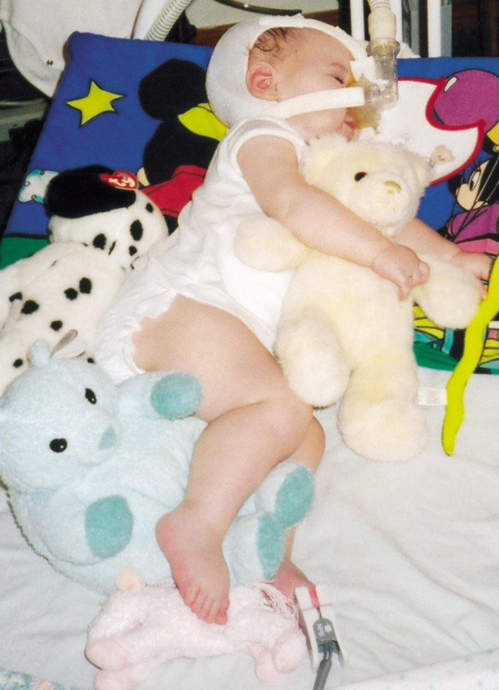 Stuffed animals are used to adjust Adrianne's position frequently.