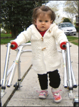 Kelly Trumpy, born with congenital myotonic dystrophy, is learning to walk using a posterior walker.