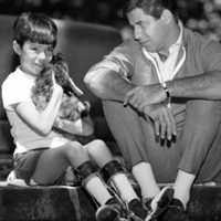 Jerry Lewis with a little boy in a cast with a dog