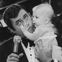 Jerry Lewis with a little baby grabbing his nose