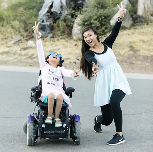 MDA Summer Camp attendee and counselor strike a pose for the camera.