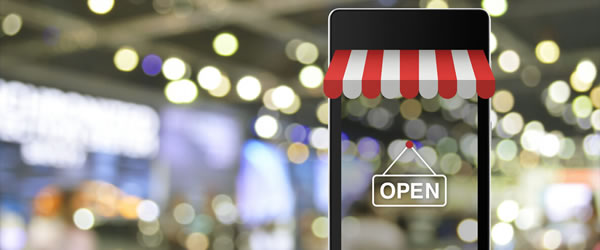 Image of an open business sign over top of a transparent cell phone