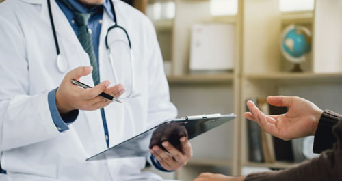 A doctor holding a pen and clipboard