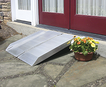 The Access4U portable folding ramp has skid-resistant aluminum decking, is hinged down the middle and includes a carrying handle.