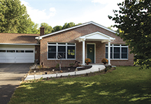 This is an elegant solution that avoids the ramp "look" altogether. The front porch was rebuilt to accept a new curved concrete walkway that rises smoothly, right up to the front door.