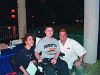 A young David Kirby poses with two of his heroes: his mom and primary caregiver, Nadine Kirby, and hot rod designer and TV personality Chip Foose.