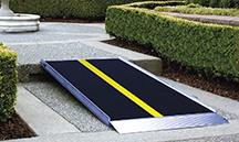 The EZ-Access Pathway Lite solid aluminum ramp features a skid-resistant surface, side curbs and a self-adjusting bottom transition plate.