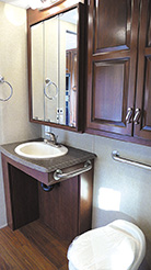 An open-front bathroom sink, left, allows easy access for a wheelchair user.