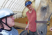 Trey Lovell and his horse, Comanche, prepare for their hippotherapy session.