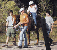 Camille Levy and her horse, Chester, return from a long ride with her therapeutic riding team.