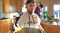 Joe Akmakjian cooking dinner with a caregiver.