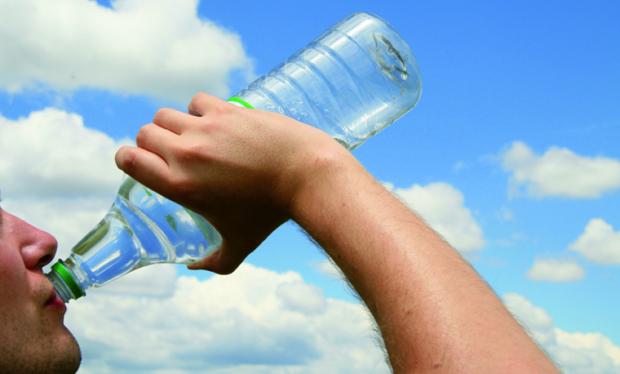 A picture of a person drinking from a bottle of water