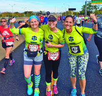 Gloria Smith (left) with MDA Team Momentum at the 2015 Marine Corps Marathon.