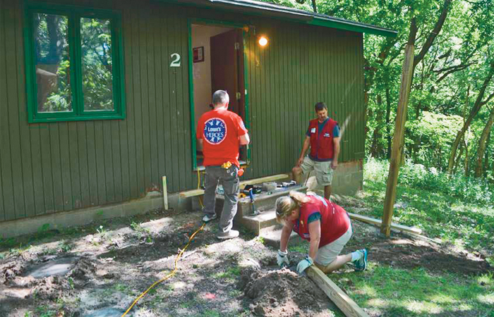 A picture of three people helping with a construction project