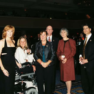 A group of six individuals networking at WOWs 2005.