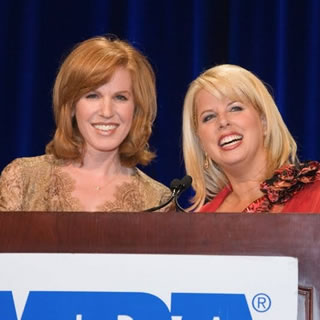 Two women speaking in front of an MDA podium at WOWs 2006.