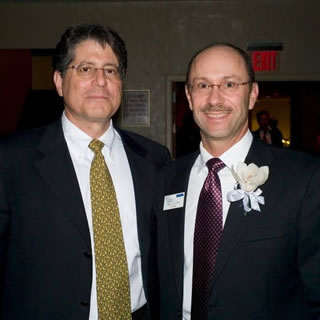 Two men in suits attending WOWs 2007.