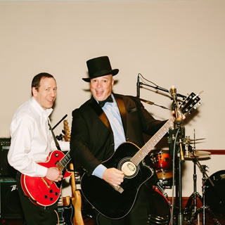 Two men with guitars playing music at WOWs 2017.