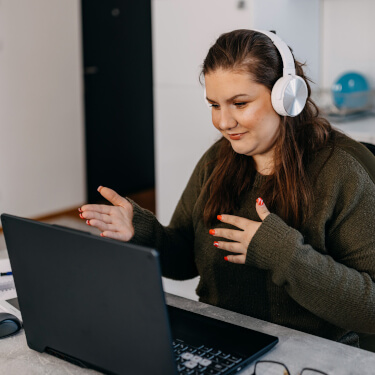 A picture of a woman working at a computer.