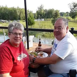 Deb Klier eating lunch in front of a lake..