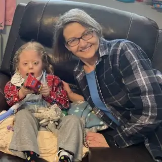 Marygrace and Jackie on a recliner.