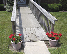 If you build a wood ramp, annual maintenance will be required to keep it safe and looking good. This wood ramp has seen better days.