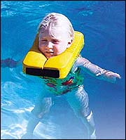 Flotation aides like this collar (above) and swim disks can help children feel secure enough to exercise in the water.