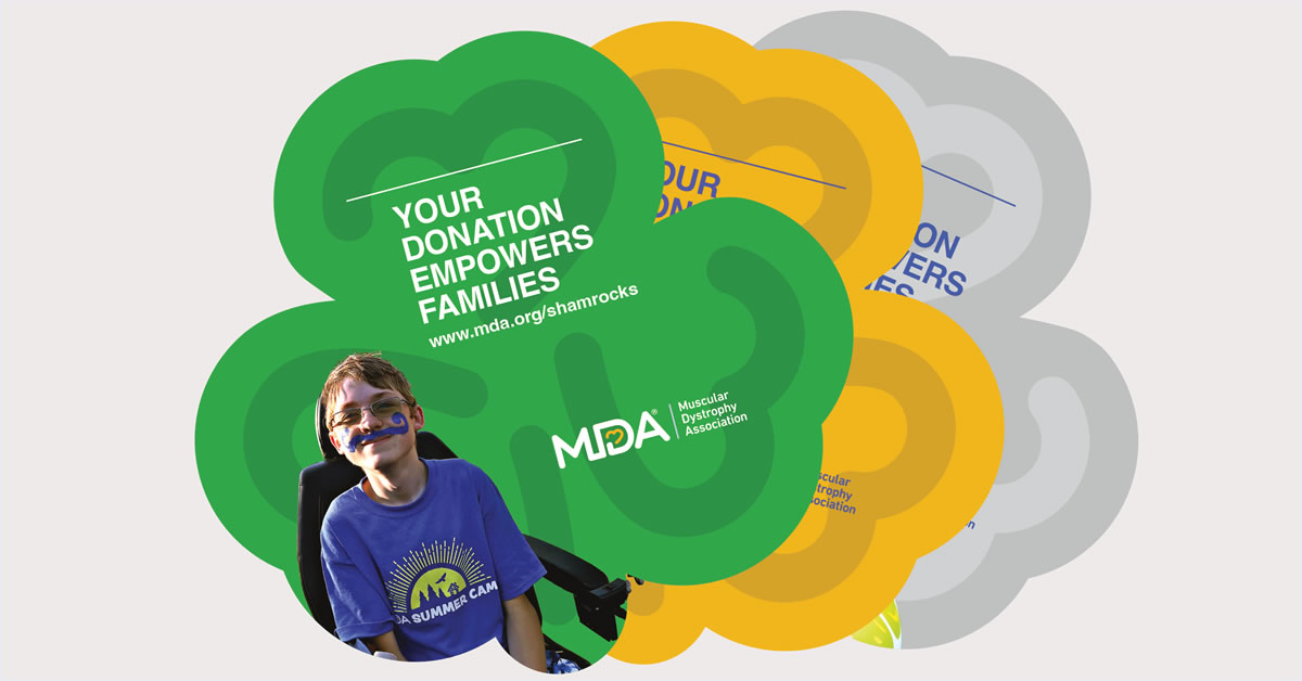 Image of a boy in a wheelchair with a blue shirt and a blue painted on mustache. MDA Shamrock pinups are in the background with the words Your Donation Empowers Families.