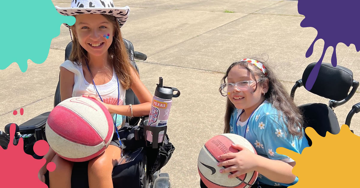 Two girls in wheelchairs on concrete with basketballs