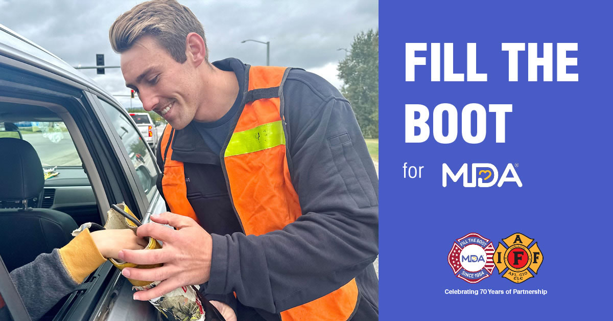 Image of a person in a car putting money into a firefighters boot.