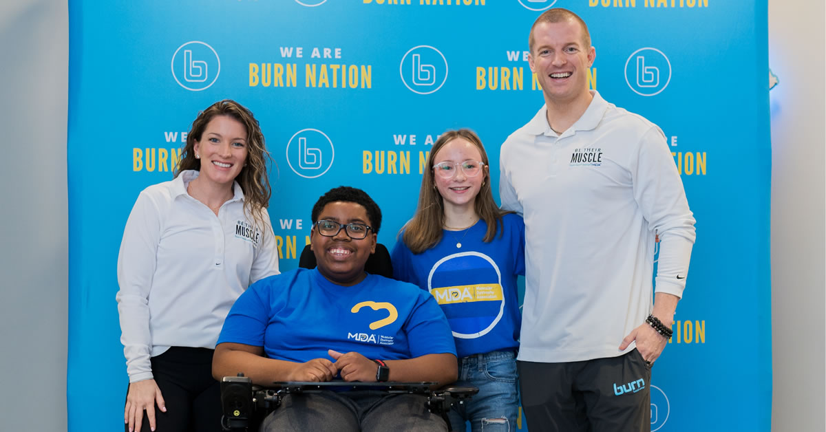 Image of people standing together in front of a Burn Boot Camp banner.