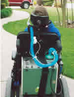 Neufeldt uses a Respironics PLV-100 volume ventilator, which fits on the back of his power chair.