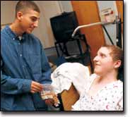 Jason's brother, Josh, visits 10 days after surgery, bringing cookies. Jason asks for a burger.