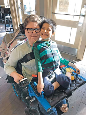 Gosho rides with his mom on a specially designed seat.