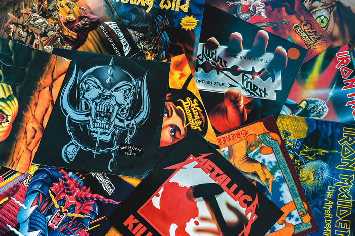 A collage of many different artworks from famous heavy metal bands, including Metallica, Iron Maiden, Judas Priest, and more