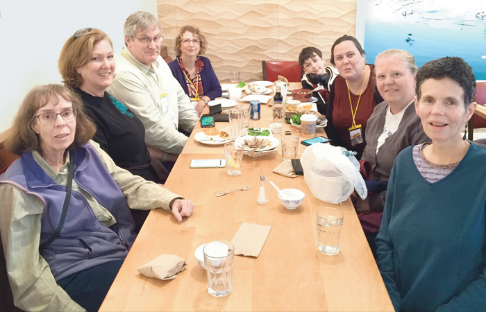 A picture of a group of people sitting at a conference table